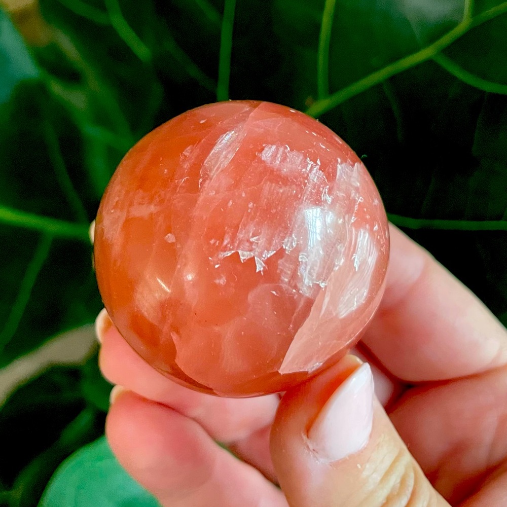 High grade rose calcite polished crystal sphere with stand